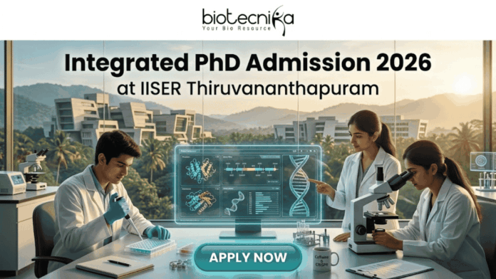 Integrated PhD Admission 2026 at IISER Thiruvananthapuram. An inspiring featured image for Integrated PhD admission, featuring three students in lab coats collaborating in a modern IISER Thiruvananthapuram laboratory during golden hour. Large text at the top reads: "Integrated PhD Admission 2026 at IISER Thiruvananthapuram", with the Biotecnika logo. Below, students are pointing at a transparent screen with DNA structures and using a microscope, with a witty "Caffeine & CRISPR" mug. A large teal "APPLY NOW" button is at the bottom center.