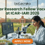Junior Research Fellow Vacancy at ICAR-IARI 2026 | MSc Life Science Candidates Apply Fast! Junior Research Fellow Vacancy at ICAR-IARI 2026 Apply Fast. A promotional image for a "Junior Research Fellow Vacancy at ICAR-IARI 2026," featuring a female scientist in a modern lab with plant samples and a view of the IARI campus. The "biotecnika" logo is at the top, and a large "APPLY NOW" button is at the bottom.