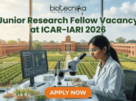 Junior Research Fellow Vacancy at ICAR-IARI 2026 Apply Fast. A promotional image for a "Junior Research Fellow Vacancy at ICAR-IARI 2026," featuring a female scientist in a modern lab with plant samples and a view of the IARI campus. The "biotecnika" logo is at the top, and a large "APPLY NOW" button is at the bottom.