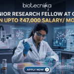 Exciting Junior Research Fellow at GBU | Earn Upto ₹47,000 Salary/ Month Junior Research Fellow at GBU Earn Upto ₹47,000 Salary Month. A job advertisement featuring a female researcher in a modern drug research lab, using a multi-channel pipette, surrounded by transparent screens displaying 3D molecular structures. Prominent text at the top reads: "JUNIOR RESEARCH FELLOW AT GBU", followed by a central banner stating: "EARN UPTO ₹47,000 SALARY/ MONTH". The biotecnika logo is at the very top, and a blue button at the bottom says: "APPLY NOW".