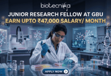 Exciting Junior Research Fellow at GBU | Earn Upto ₹47,000 Salary/ Month Junior Research Fellow at GBU Earn Upto ₹47,000 Salary Month. A job advertisement featuring a female researcher in a modern drug research lab, using a multi-channel pipette, surrounded by transparent screens displaying 3D molecular structures. Prominent text at the top reads: "JUNIOR RESEARCH FELLOW AT GBU", followed by a central banner stating: "EARN UPTO ₹47,000 SALARY/ MONTH". The biotecnika logo is at the very top, and a blue button at the bottom says: "APPLY NOW".