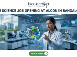 Life Science Job Opening at Alcon in Bangalore | Apply Before It’s Gone Life Science Job Opening at Alcon in Bangalore. A corporate job advertisement banner for a Life Science Job Opening at Alcon in Bangalore. The image features a female scientist of South Asian descent in a high-tech laboratory, interacting with a glowing holographic 3D protein-drug molecular model. The background shows advanced lab equipment, data monitors, and a view of modern Bangalore buildings through a large window. The Biotecnika logo is at the top center, the headline is in bold dark text, and a green 'Apply Now' button is located at the bottom.