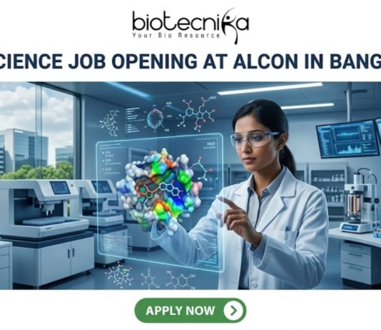 Life Science Job Opening at Alcon in Bangalore | Apply Before It’s Gone Life Science Job Opening at Alcon in Bangalore. A corporate job advertisement banner for a Life Science Job Opening at Alcon in Bangalore. The image features a female scientist of South Asian descent in a high-tech laboratory, interacting with a glowing holographic 3D protein-drug molecular model. The background shows advanced lab equipment, data monitors, and a view of modern Bangalore buildings through a large window. The Biotecnika logo is at the top center, the headline is in bold dark text, and a green 'Apply Now' button is located at the bottom.