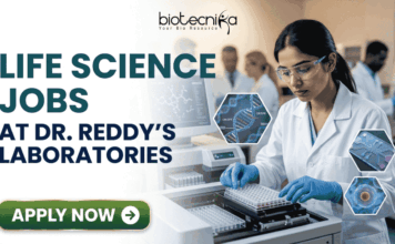 Life Science Jobs at Dr. Reddy’s Laboratories | BSc & MSc Candidates Apply Now! Life Science Jobs at Dr. Reddy's Laboratories BSc & MSc Candidates Apply Now! A professional corporate recruitment banner for "LIFE SCIENCE JOBS AT DR. REDDY'S LABORATORIES" featuring the Biotecnika logo at the top. The image depicts a focused female scientist of Indian heritage wearing a white lab coat, safety goggles, and blue gloves, working with a modern automated liquid handling system and microplates. Hexagonal graphics to the right showcase scientific concepts like a DNA helix labeled 'CRISPR', a microfluidic chip, and a biological cell. In the background, a team of researchers is visible in a clean, state-of-the-art laboratory environment. A prominent green "APPLY NOW" button with a white arrow is located at the bottom left.