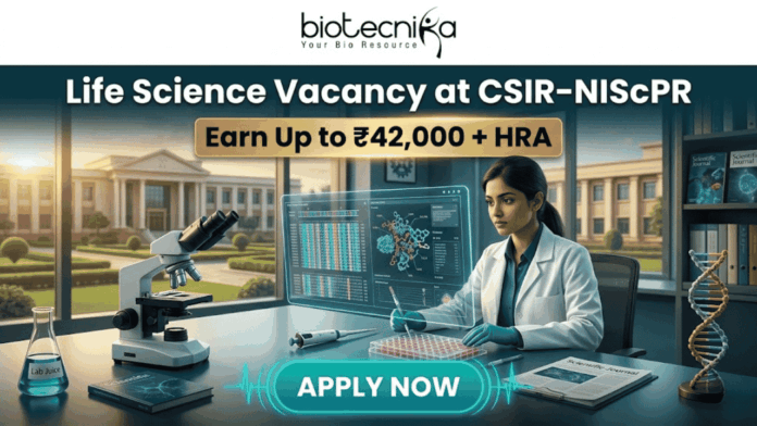 Life Science Vacancy at CSIR-NIScPR Earn Up to ₹42,000 + HRA Life Science Vacancy at CSIR-NIScPR Earn Up to ₹42,000 + HRA. A promotional job advertisement banner for a "Life Science Vacancy at CSIR-NIScPR." The central image features a female researcher in a lab coat and gloves at a sophisticated laboratory desk. She is using a micropipette with a futuristic, transparent data display. Foreground objects include a microscope, a multi-well plate, stacks of scientific journals, and a DNA helix model. Behind her are large windows showing a grand, classical-style campus building under a sunny sky, representing the institute. At the top center, the Biotecnika "Your Bio Resource" logo is visible. The text reads: "Life Science Vacancy at CSIR-NIScPR", with a prominent gold banner below highlighting: "Earn Up to ₹42,000 + HRA". A large, pulsing teal button at the bottom center says "APPLY NOW."