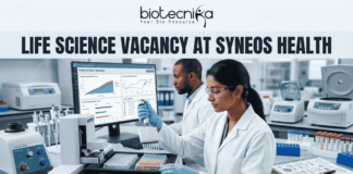 Life Science Vacancy at Syneos Health | BSc Candidates Apply Now Life Science Vacancy at Syneos Health BSc Candidates Apply Now. A complete job advertisement featured image banner. At the very top center, it features the full Biotecnika logo and tagline ("biotecnika", abstract human-leaf figure, "Your Bio Resource"). Directly below, a large text headline reads: "LIFE SCIENCE VACANCY AT SYNEOS HEALTH". The main scene is a photograph of a modern, well-equipped laboratory with two focused researchers. A female researcher in the foreground is actively pipetting over microtiter plates. Behind her, her male colleague works at a large computer station. The monitor screen is clearly legible and displays complex "PHASE III TRIAL TRACKING" data, graphs, and clinical recruitment charts. Advanced lab equipment like an automated liquid handling system and color-coded samples are on the bench, alongside a lab notebook with molecular doodles. At the bottom center, a prominent deep teal-blue button with bold white text displays "APPLY NOW".