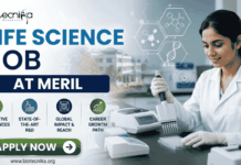 Meril Life Science Job 2026 | Research Role in Gujarat for M.Sc & PhD Candidates Meril Life Science Job 2026 Research Role in Gujarat for M.Sc & PhD Candidates. A professional recruitment banner for a "Life Science Job at Meril," featuring the Biotecnika logo at the top left. On the right, a female scientist in a white lab coat is shown working in a bright, modern laboratory, using a multichannel pipette on a microplate. The left side displays the bold headline "LIFE SCIENCE JOB AT MERIL" and four circular icons representing: Innovative Bio-sciences, State-of-the-Art R&D, Global Impact & Reach, and Career Growth Path. The background features floating scientific diagrams and a view of a research campus through a window. A prominent green "Apply Now" button and the website "www.biotecnika.org" are located at the bottom.