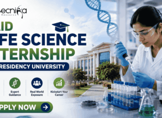 Paid Life Science Internship at Presidency University | Opportunity for MSc Candidates! Paid Life Science Internship at Presidency University Project Intern Opportunity for MSc Candidates! Featured banner for “Paid Life Science Internship at Presidency University” featuring the Biotecnika logo at the top, a life sciences researcher working in a modern laboratory, a university campus backdrop, biotechnology-themed graphics, and a bold “Apply Now” button at the bottom.
