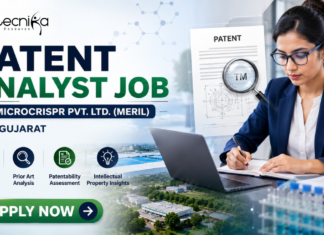 Latest Patent Analyst Job at Microcrispr Pvt. Ltd. (Meril) in Gujarat | Apply Now Patent Analyst Job at Microcrispr Pvt. Ltd. (Meril) in Gujarat Apply. Featured banner for “Patent Analyst Job at Microcrispr Pvt. Ltd. (Meril) in Gujarat” featuring the Biotecnika logo at the top, a professional patent analyst working on a laptop in a modern office setting, patent document and intellectual property-themed graphics, biotechnology research visuals, and a bold “Apply Now” button at the bottom.