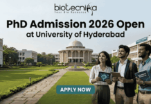 PhD Admission 2026 Open at University of Hyderabad | Research Career Opportunity PhD Admission 2026 Open at University of Hyderabad. An advertisement for PhD Admission 2026 at the University of Hyderabad. The image features a photo of the university campus with three smiling people walking on a pathway, one holding a tablet showing a molecular diagram and another holding a book titled 'Advanced Research'. The biotecnika logo is at the top center. The main headline is 'PhD Admission 2026 Open at University of Hyderabad'. There is a green 'APPLY NOW' button with subtext providing a website and application deadline: 'Visit www.biotecnika.org for application details. Application Deadline: October 2025'.