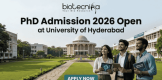PhD Admission 2026 Open at University of Hyderabad | Research Career Opportunity PhD Admission 2026 Open at University of Hyderabad. An advertisement for PhD Admission 2026 at the University of Hyderabad. The image features a photo of the university campus with three smiling people walking on a pathway, one holding a tablet showing a molecular diagram and another holding a book titled 'Advanced Research'. The biotecnika logo is at the top center. The main headline is 'PhD Admission 2026 Open at University of Hyderabad'. There is a green 'APPLY NOW' button with subtext providing a website and application deadline: 'Visit www.biotecnika.org for application details. Application Deadline: October 2025'.