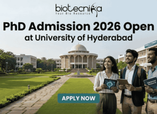 PhD Admission 2026 Open at University of Hyderabad. An advertisement for PhD Admission 2026 at the University of Hyderabad. The image features a photo of the university campus with three smiling people walking on a pathway, one holding a tablet showing a molecular diagram and another holding a book titled 'Advanced Research'. The biotecnika logo is at the top center. The main headline is 'PhD Admission 2026 Open at University of Hyderabad'. There is a green 'APPLY NOW' button with subtext providing a website and application deadline: 'Visit www.biotecnika.org for application details. Application Deadline: October 2025'.