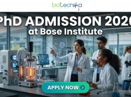 PhD Admission 2026 at Bose Institute Life Science Opportunity. A professional and high-tech featured image for the Project Research Scientist Recruitment 2026 at ICMR-NIN. The image depicts a female scientist in a white lab coat interacting with a glowing, transparent digital interface that displays complex nutritional genomics data, 3D DNA structures, and metabolic charts. The background shows a modern, sunlit laboratory with a city skyline visible through the window. The Biotecnika logo is featured at the top center, and a prominent teal "Apply Now" button is positioned at the bottom.