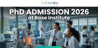 PhD Admission 2026 at Bose Institute | Dream Opportunity for Life Science Candidates in India! PhD Admission 2026 at Bose Institute Life Science Opportunity. A professional and high-tech featured image for the Project Research Scientist Recruitment 2026 at ICMR-NIN. The image depicts a female scientist in a white lab coat interacting with a glowing, transparent digital interface that displays complex nutritional genomics data, 3D DNA structures, and metabolic charts. The background shows a modern, sunlit laboratory with a city skyline visible through the window. The Biotecnika logo is featured at the top center, and a prominent teal "Apply Now" button is positioned at the bottom.