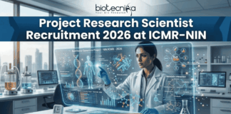 Project Research Scientist Recruitment 2026 at ICMR-NIN | Earn Upto Rs. 56,000/- Project Research Scientist Recruitment 2026 at ICMR-NIN. A professional and high-tech featured image for the Project Research Scientist Recruitment 2026 at ICMR-NIN. The image depicts a female scientist in a white lab coat interacting with a glowing, transparent digital interface that displays complex nutritional genomics data, 3D DNA structures, and metabolic charts. The background shows a modern, sunlit laboratory with a city skyline visible through the window. The Biotecnika logo is featured at the top center, and a prominent teal "Apply Now" button is positioned at the bottom.