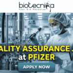 Quality Assurance Job at Pfizer BSc & MSc Biotech Candidates Apply Now. A promotional job banner with the Biotecnika logo at the top. Large yellow and white text reads: 'QUALITY ASSURANCE JOB at PFIZER'. The background is a photograph of a person in a full cleanroom suit and goggles, scanning equipment in a state-of-the-art pharmaceutical manufacturing lab. A turquoise 'APPLY NOW' button is at the bottom.