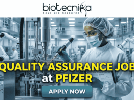 Quality Assurance Job at Pfizer | BSc & MSc Biotech Candidates Apply Now Quality Assurance Job at Pfizer BSc & MSc Biotech Candidates Apply Now. A promotional job banner with the Biotecnika logo at the top. Large yellow and white text reads: 'QUALITY ASSURANCE JOB at PFIZER'. The background is a photograph of a person in a full cleanroom suit and goggles, scanning equipment in a state-of-the-art pharmaceutical manufacturing lab. A turquoise 'APPLY NOW' button is at the bottom.