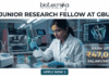 Research Jobs Alert: Gujarat Biotechnology University JRF Recruitment 2026 – Earn ₹47,000/Month Research Job at Gujarat Biotechnology University with ₹47,000 Pay. A job advertisement banner featuring the Biotecnika logo and the headline 'JUNIOR RESEARCH FELLOW AT GBU'. The visual depicts a female scientist in a modern lab using a multi-channel pipette, surrounded by scientific equipment and a computer monitor showing a molecular structure. A prominent side panel highlights the salary as 'EARN UPTO ₹47,000 SALARY/MONTH'. At the bottom, a teal button says 'APPLY NOW >'.