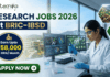 Research Jobs at BRIC-IBSD | Walk-In Interview for Life Science Candidates Research Jobs at BRIC-IBSD Walk-In Interview for Life Science Candidates. A professional recruitment banner for biotecnika advertising "Research Jobs 2026 at BRIC-IBSD." The top left features the biotecnika logo, and the headline text is prominent in blue and green. A circular blue callout on the left highlights the compensation: "Earn Upto ₹58,000 + HRA/ Month." On the right, a focused female scientist of professional and realistic appearance, wearing a white lab coat and safety glasses, is seated at a modern lab desk, using a pipette to fill a microplate. In the background, computer monitors display complex data including molecular structures and "Bioresource mapping" on a world map. Through a large window, a scenic modern building, perhaps the BRIC-IBSD institute, is visible in a lush environment. Two hexagonal icons on the far right show a network diagram over fresh produce and a sustainability tree icon. A prominent green "APPLY NOW" button with an arrow is at the bottom left.