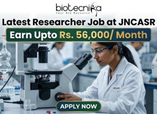 Latest Researcher Job at JNCASR | Earn Upto Rs. 56,000/ Month Researcher Job at JNCASR 2026 Life Science Career. An advertisement banner for a Researcher Job at JNCASR, featuring a female scientist in a lab coat using a microscope in a laboratory. Key text states: "Latest Researcher Job at JNCASR", "Earn Upto Rs. 56,000/ Month", with a prominent "APPLY NOW" button at the bottom and a "biotecnika" logo at the top.