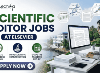Scientific Editor Jobs at Elsevier | PhD Candidates Apply Now! Scientific Editor Jobs at Elsevier | PhD Candidates Apply Now! A professional featured image for "Scientific Editor Jobs at Elsevier" featuring the Biotecnika logo at the top left. On the right, a woman in a grey business blazer is seated at a desk, focused on a computer screen showing an edited research manuscript. The left side displays the bold headline "SCIENTIFIC EDITOR JOBS AT ELSEVIER" along with three icons representing research evaluation, scientific communication, and shaping the academic future. The background includes floating scientific diagrams and a scenic coastal building view, with a prominent "Apply Now" button at the bottom.