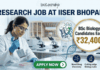 ₹32,400 Salary Research Job at IISER Bhopal | BSc Biology Candidates Apply Now ₹32,400 Salary Research Job at IISER Bhopal BSc Biology Candidates Apply Now. A recruitment banner for a "RESEARCH JOB AT IISER BHOPAL" by Biotecnika. The image features a female scientist in a lab coat pipetting into a microplate in a modern laboratory. A gold circular callout highlights that BSc Biology candidates can earn ₹32,400. The background shows the IISER Bhopal campus, molecular models (protein and DNA), and lab equipment. At the bottom right, three icons with text represent "Novel Drug Discovery," "Cutting-edge Biology Labs," and "Expert Mentorship." A prominent green "APPLY NOW" button is at the bottom center.