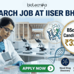 ₹32,400 Salary Research Job at IISER Bhopal | BSc Biology Candidates Apply Now ₹32,400 Salary Research Job at IISER Bhopal BSc Biology Candidates Apply Now. A recruitment banner for a "RESEARCH JOB AT IISER BHOPAL" by Biotecnika. The image features a female scientist in a lab coat pipetting into a microplate in a modern laboratory. A gold circular callout highlights that BSc Biology candidates can earn ₹32,400. The background shows the IISER Bhopal campus, molecular models (protein and DNA), and lab equipment. At the bottom right, three icons with text represent "Novel Drug Discovery," "Cutting-edge Biology Labs," and "Expert Mentorship." A prominent green "APPLY NOW" button is at the bottom center.