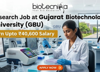 ₹40,600 Salary Research Job at Gujarat Biotechnology University (GBU) JRF & SRF Openings. A focused female researcher in a white lab coat uses a multi-channel pipette on a microplate within a modern GBU laboratory. Large bold text reads: 'Research Job at Gujarat Biotechnology University (GBU)'. A yellow banner highlights 'Earn Upto ₹40,600 Salary'. The Biotecnika logo is at the top. The background features GBU lab equipment, a monitor with DNA graphs, another researcher, and GBU campus views. At the bottom center is an orange 'APPLY NOW' button with a right arrow.