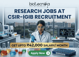 ₹42,000 Salary Research Jobs at Institute of Life Sciences | Apply Now ₹42,000 Salary Research Jobs at Institute of Life Sciences Apply Now. A job recruitment banner from Biotecnika for CSIR-IGIB. The headline reads 'RESEARCH JOBS AT CSIR-IGIB RECRUITMENT'. A female scientist in a lab coat uses a multi-channel pipette. The desk features beakers, a box of 'DRUG CANDIDATE' vials, and a monitor with a 3D molecular structure. A campus of buildings is visible through a large window. A gold banner highlights 'GET UPTO ₹42,000 SALARY/ MONTH'. An 'Apply Now' button is at the bottom.