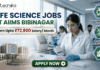 ₹72,800 Salary AIIMS Bibinagar Life Science Jobs 2026 | Research & Microbiology Openings ₹72,800 Salary AIIMS Bibinagar Life Science Jobs 2026 Research & Microbiology Openings. A professional corporate recruitment banner for "LIFE SCIENCE JOBS AT AIIMS BIBINAGAR" featuring the Biotecnika logo at the top. The image displays a focused female scientist in a white lab coat and safety glasses using a multichannel pipette in a state-of-the-art laboratory. An inset on the bottom left shows the modern AIIMS Bibinagar campus building. A prominent gold-bordered callout highlights "Earn Upto ₹72,800 Salary/ Month." Three teal hexagonal icons on the right represent "ADVANCED MEDICAL RESEARCH," "DIAGNOSTICS & GENETICS," and "CLINICAL APPLICATIONS." A green "APPLY NOW" button with a white arrow is positioned at the bottom center.