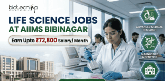 ₹72,800 Salary AIIMS Bibinagar Life Science Jobs 2026 | Research & Microbiology Openings ₹72,800 Salary AIIMS Bibinagar Life Science Jobs 2026 Research & Microbiology Openings. A professional corporate recruitment banner for "LIFE SCIENCE JOBS AT AIIMS BIBINAGAR" featuring the Biotecnika logo at the top. The image displays a focused female scientist in a white lab coat and safety glasses using a multichannel pipette in a state-of-the-art laboratory. An inset on the bottom left shows the modern AIIMS Bibinagar campus building. A prominent gold-bordered callout highlights "Earn Upto ₹72,800 Salary/ Month." Three teal hexagonal icons on the right represent "ADVANCED MEDICAL RESEARCH," "DIAGNOSTICS & GENETICS," and "CLINICAL APPLICATIONS." A green "APPLY NOW" button with a white arrow is positioned at the bottom center.