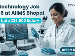 Biotechnology Job 2026 at AIIMS Bhopal with ₹33,600 Salary – Apply Now! Biotechnology Job 2026 at AIIMS Bhopal with ₹33,600 Salary – Apply Now! A corporate-style job featured image banner (1280x720) for "Biotechnology Job 2026 at AIIMS Bhopal" featuring the Biotecnika CRO logo at the top right. On the left, the main headline and a bright teal highlight bar reading "Earn Upto ₹33,600 Salary" are prominently displayed. The right side features a realistic, smiling young Indian female scientist in a white lab coat and blue gloves carefully using a pipette over a well plate in a modern medical laboratory. A computer monitor showing molecular structures is visible in the background, and a glowing teal "APPLY NOW" button sits at the bottom right.
