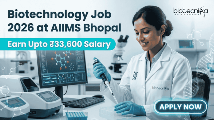 Biotechnology Job 2026 at AIIMS Bhopal with ₹33,600 Salary – Apply Now! Biotechnology Job 2026 at AIIMS Bhopal with ₹33,600 Salary – Apply Now! A corporate-style job featured image banner (1280x720) for "Biotechnology Job 2026 at AIIMS Bhopal" featuring the Biotecnika CRO logo at the top right. On the left, the main headline and a bright teal highlight bar reading "Earn Upto ₹33,600 Salary" are prominently displayed. The right side features a realistic, smiling young Indian female scientist in a white lab coat and blue gloves carefully using a pipette over a well plate in a modern medical laboratory. A computer monitor showing molecular structures is visible in the background, and a glowing teal "APPLY NOW" button sits at the bottom right.