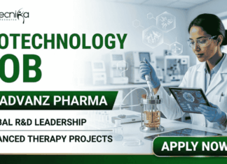 Hybrid Biotechnology Job At ADVANZ PHARMA | Apply Before It’s Gone! Hybrid Biotechnology Job At ADVANZ PHARMA Apply Before It's Gone! A professional promotional banner for a "Biotechnology Job at ADVANZ PHARMA." The top left features the Biotecnika logo. The bold main header on the left reads "BIOTECHNOLOGY JOB AT ADVANZ PHARMA" in a clean green and dark gray font layout, followed by two bullet points: "GLOBAL R&D LEADERSHIP" and "ADVANCED THERAPY PROJECTS". On the right side, a female researcher in a white lab coat, safety glasses, and blue gloves holds a digital tablet while carefully using a pipette with a benchtop laboratory bioreactor. The background shows a bright, modern, high-tech pharmaceutical research laboratory. A prominent dark green "APPLY NOW" button with a white right-pointing arrow sits at the bottom right.